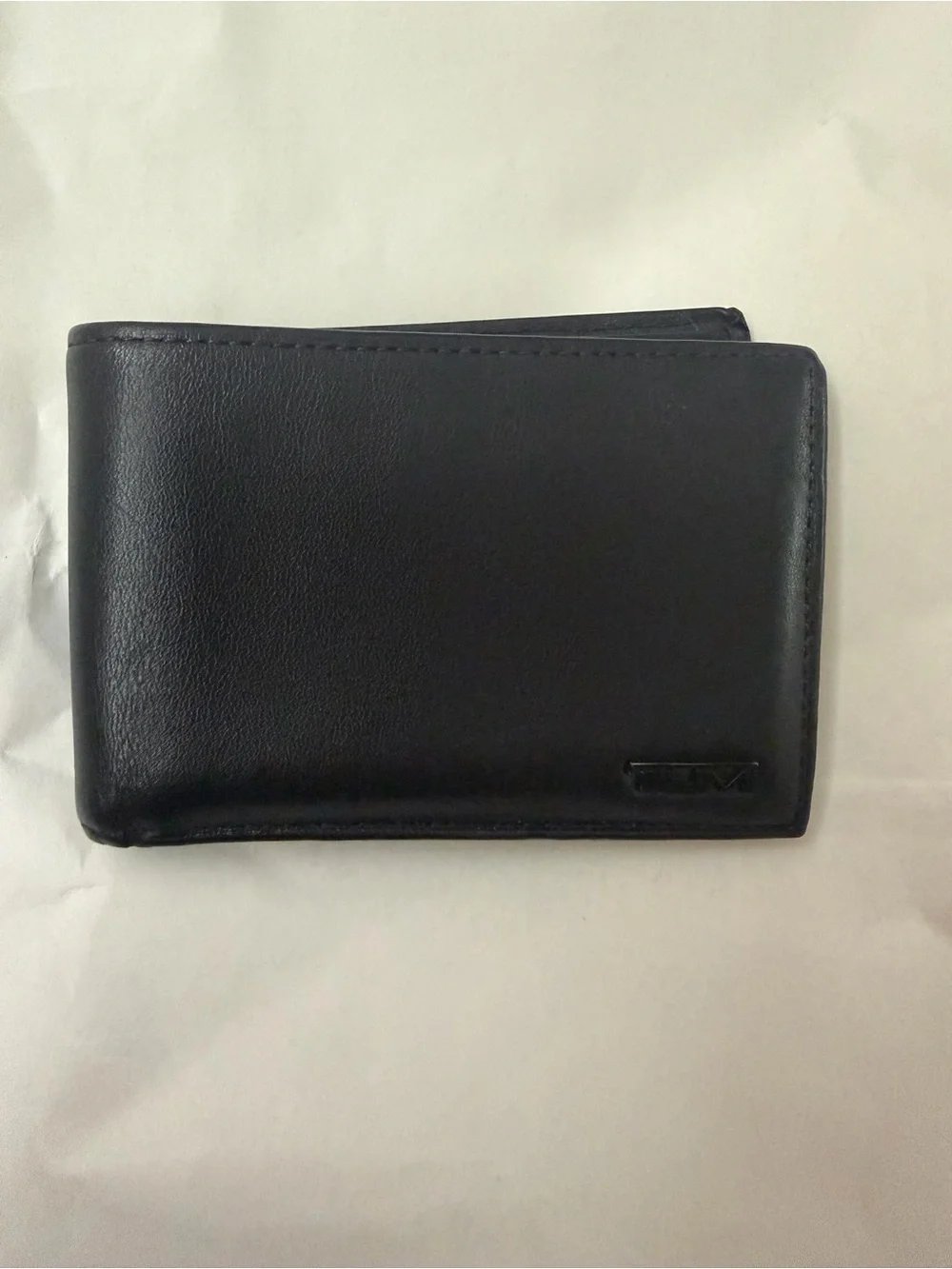 Tumi Black Leather Men's Wallet with Embossed Logo